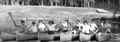 Photo of Juliette Gordon Low posing with some of the nation's first Girl Scouts. &copy; GSUSA. All rights reserved.