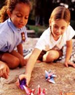 Photo of two Girl Scouts making origami. &copy; GSUSA. All rights reserved. (Photographer: Lori Adamski-Peek)