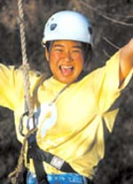 Photo of a girl with white helmet zip-lining. &copy; GSUSA. All rights reserved. (Photographer: Lori Adamski-Peek)