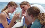 Photo of girls examining water specimen. (Ivy Kelley, Florida Keys National Marine Sanctuary)