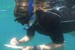 Photo of girl using writing tablet underwater. (Michael Kelly, NOAA Office of Ocean Exploration)