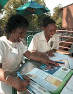 Photo of Girl Scout volunteers at table. &copy; GSUSA. All rights reserved. (Photo credit: Quad Photo/Karineh Gurjian-Angelo/Dedjora Von Jutaz)