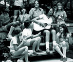 Photo of Girl Scouts singing with guitarist. © GSUSA. All rights reserved.