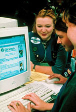 Photo of three Girl Scouts surfing the Web.