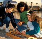 Photo of volunteers leading beach clean-up with girls.