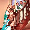 Photo of Junior Girl Scouts standing on a staircase inside the Juliette Gordon Low Birthplace National Center. (Photo courtesy of the Birthplace)