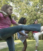 Photo of Junior Girl Scouts kicking outdoors. &copy; GSUSA. All rights reserved. (Photographer: Quad Photo/Karineh Gurjian-Angelo/Dedjora Von Jutaz)