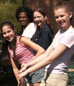 Photo of girls standing on a deck outdoors. &copy; GSUSA. All rights reserved. (Photographer: Quad Photo/Karineh Gurjian-Angelo/Dedjora Von Jutaz)