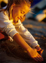 Photo of a Girl Scout stretching on the beach. &copy; GSUSA. All rights reserved. (Photographer: Lori Adamski-Peek)