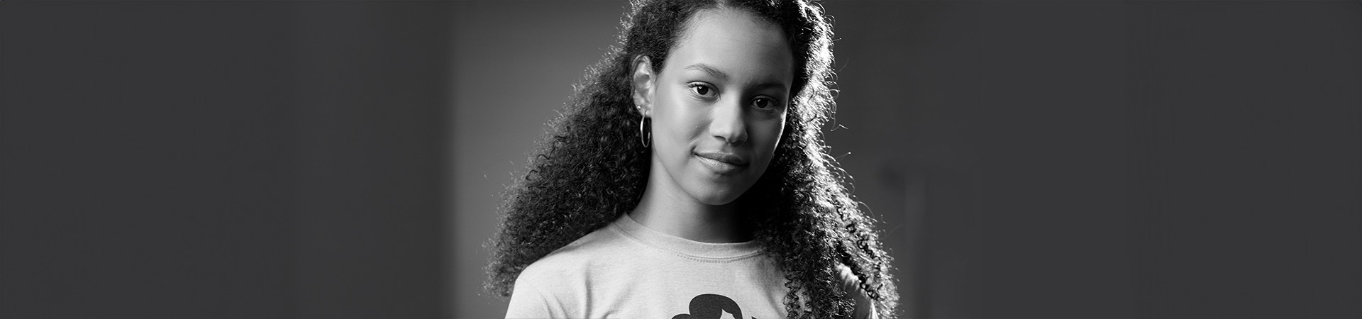 Black and white photo of Minely, a National Gold Award Girl Scout, in a Girl Scout T-shirt. 