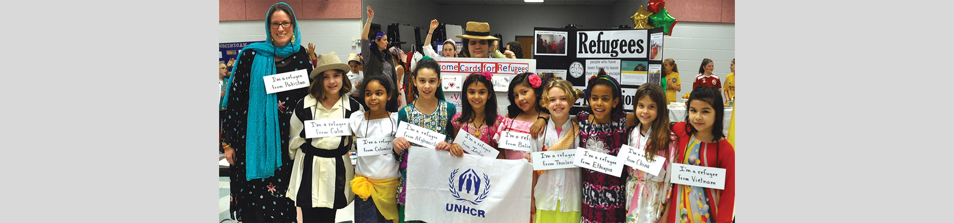 Troop 3173 holds UNHCR flag at World Thinking Day event. 