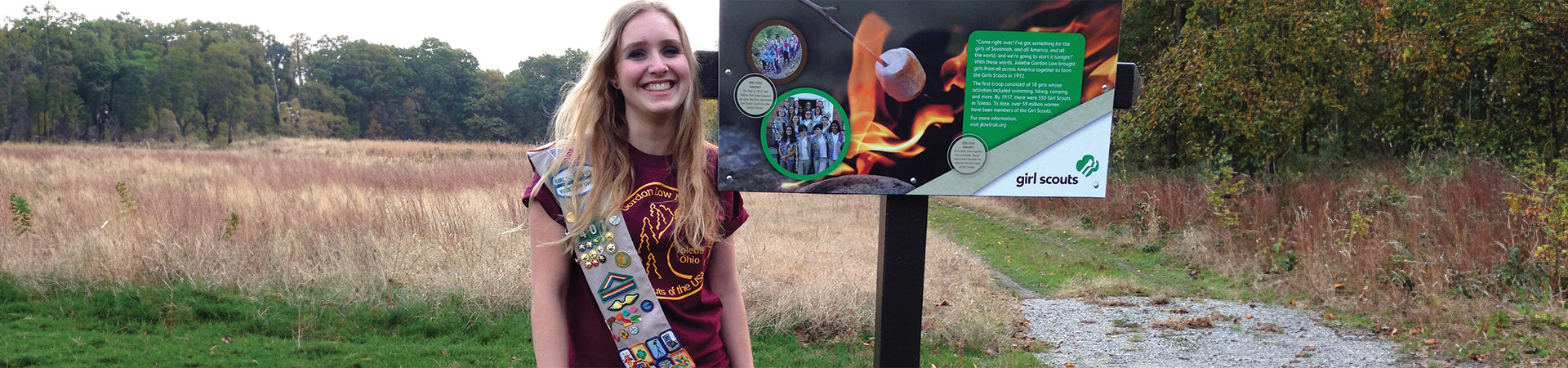  Ellie Leonard smiles big by the sign she made for the first-ever official Girl Scout hiking trail  